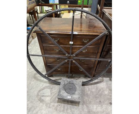 A garden wheel ornament and an urn 