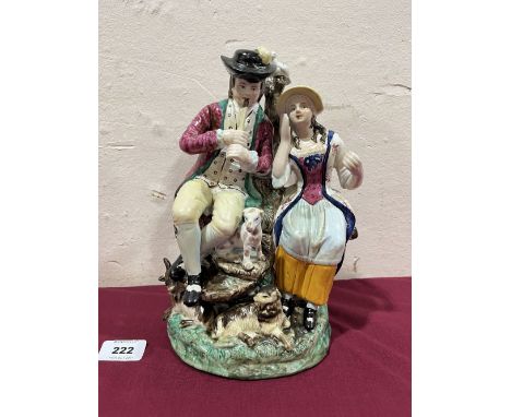 A Staffordshire group of a gentleman playing a pipe with lady companion, hound and goat. 10' high