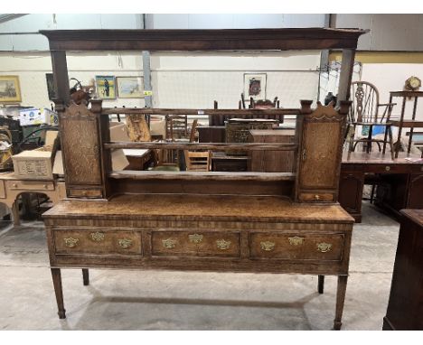 A George III oak and mahogany crossbanded dresser, the raised open rack with cupboards and spice drawers over base with three