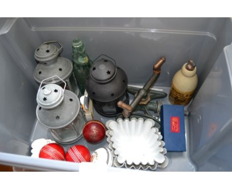 A box containing a sprayer; enamel jelly moulds; candle lanterns; cricket balls etc