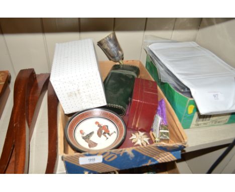 A tray containing a silver plated goblet; a Caithness glass vase; a white metal pot and cover; a Greek pottery dish etc.