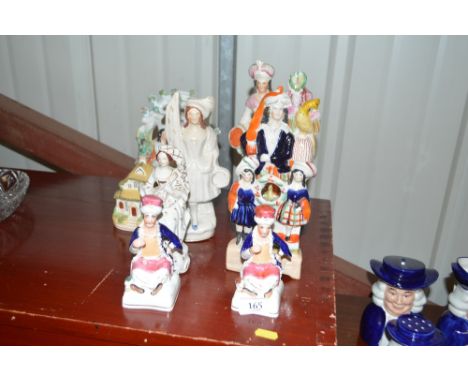 Eight various Staffordshire figures and figure groups; and a Staffordshire model cottage