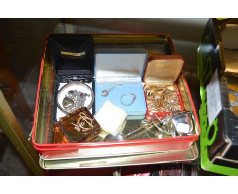 A tin containing a Sterling silver bangle, a silver mustard pot, simulated pearl necklace, a yellow metal equestrian brooch, 