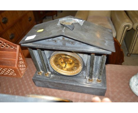 A late Victorian black slate two hole mantel clock of architectural form