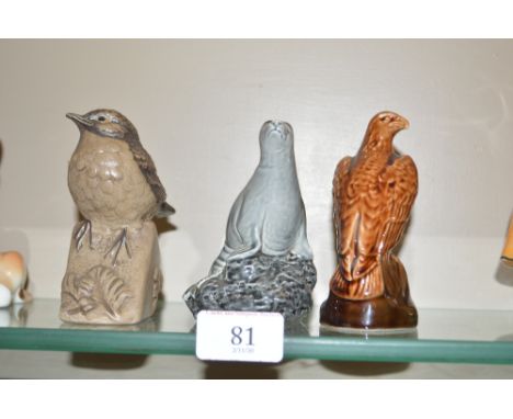 Two Beswick decanters and contents; and a Poole pottery bird