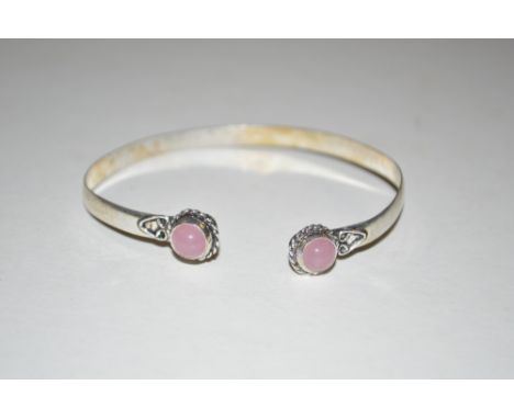A white metal and rose quartz set bangle 