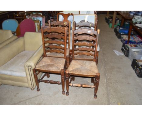 A set of four oak ladder back and rush seated chairs