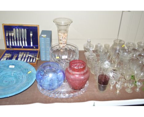 Five items of glassware to include a trumpet shaped vase; a large glass bowl; a ruby glass vase etc.