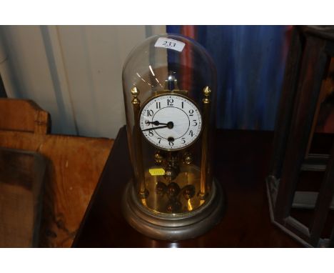 An Anniversary clock under glass dome 