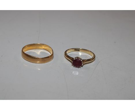 A 22ct gold wedding band, approx. 2gms AF, ring size P; and an 18ct gold ring set with ruby coloured stone, ring size M/N, ap