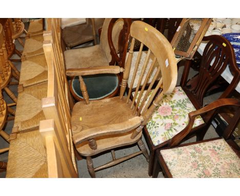 A 19th Century elm seated stick back kitchen elbow chair