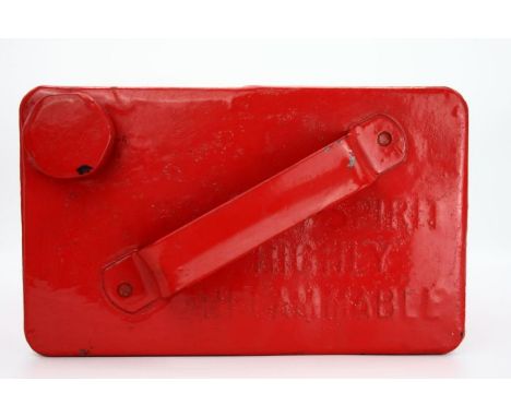A vintage bright red - recently painted - metal petrol can. No specific branding. Top handle, words embossed on the top of th