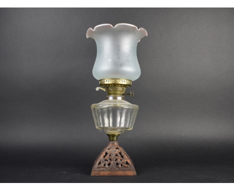 A Late Victorian Oil Lamp with Pierced Cast Iron Base, Clear Glass Reservoir and Etched Shade, 45cms High