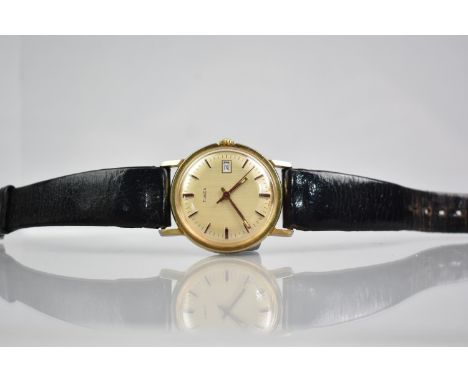 A Vintage Gold Plated Timex Wrist Watch having Champagne Dial, Baton Hour Indicators and Date Aperture at 3 O'Clock, Face Sta