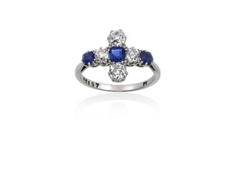 A Sapphire and Diamond Ringthe cross motif set throughout with cushion shaped sapphires and old cut diamonds, in white claw s