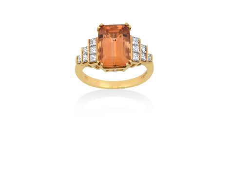 An 18 Carat Gold Orange Topaz and Diamond Ringthe emerald-cut orange topaz in a yellow double claw setting, to stepped prince