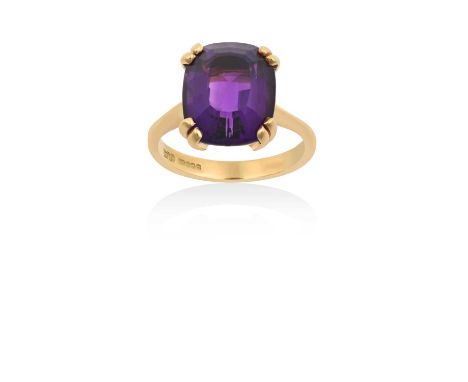 An 18 Carat Gold Amethyst Ringthe cushion shaped amethyst in a yellow double claw setting, to a tapered shoulder plain polish