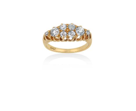 A Diamond Ring four old cut diamonds, flanked by graduated pairs of old cut diamonds, in yellow claw settings, to a tapered s