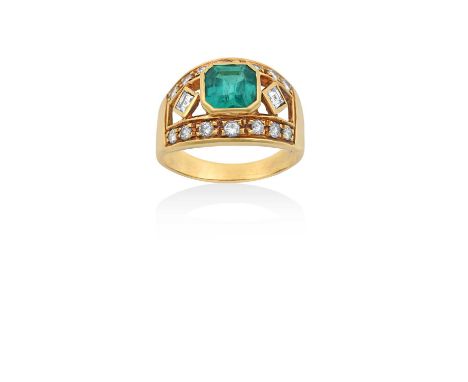 An Emerald and Diamond Ringthe emerald-cut emerald flanked by square step cut diamonds, to a border of round brilliant cut di