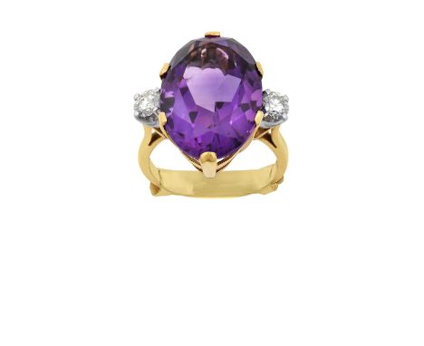 A 9 Carat Gold Amethyst and Diamond Three Stone Ringthe oval cut amethyst in a yellow claw setting, flanked by round brillian