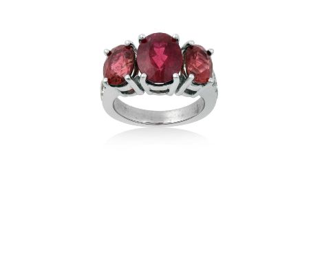 A Pink Tourmaline and Diamond Ringthree graduated pink tourmalines in white claw settings, flanked by trios of round brillian