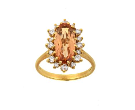 An 18 Carat Gold Topaz and Diamond Cluster Ringthe oval cut topaz within a border of round brilliant cut diamonds, in yellow 