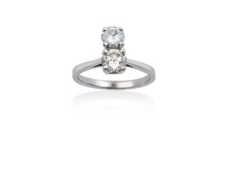 An 18 Carat White Gold Diamond Two Stone Ringthe round brilliant cut diamonds aligned up the finger, in claw settings, to a t