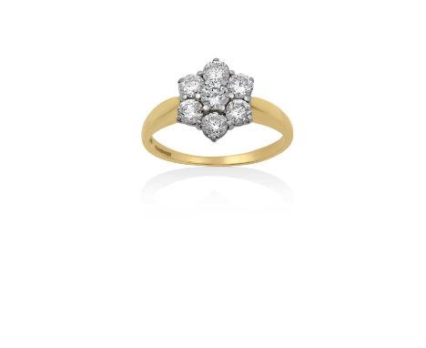 An 18 Carat Gold Diamond Cluster Ringthe central raised round brilliant cut diamond within a border of round brilliant cut di