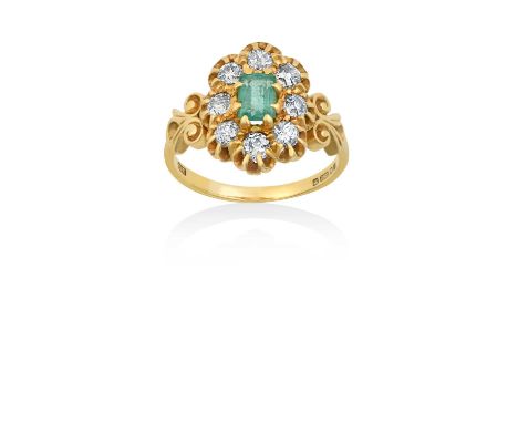 An 18 Carat Gold Emerald and Diamond Cluster Ringthe emerald-cut emerald within a border of old cut diamonds, in yellow claw 