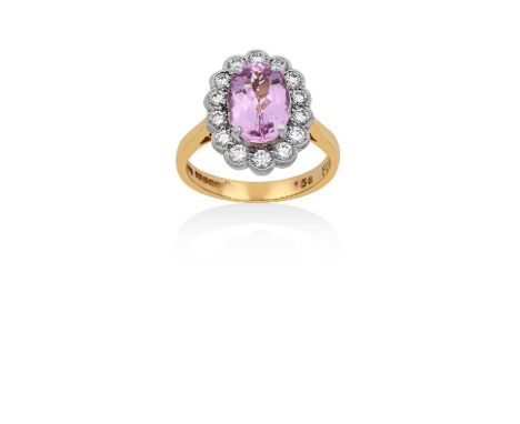 An 18 Carat Gold Pink Topaz and Diamond Cluster Ringthe oval cut pink topaz in a white four claw setting, within a border of 