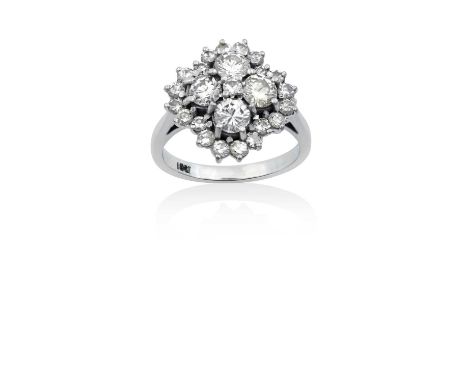 A Diamond Cluster Ringa cluster of four round brilliant cut diamonds with a smaller round brilliant cut diamond centrally, wi