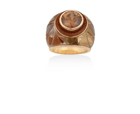 A Citrine, Enamel and Glass Ringthe round cut citrine in a yellow rubbed over setting, to an orange enamel border, to a glass