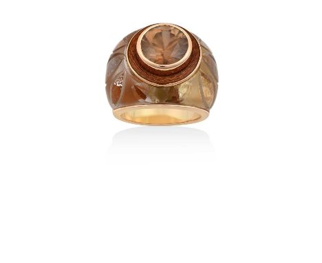 A Citrine, Enamel and Glass Ringthe round cut citrine in a yellow rubbed over setting, to an orange enamel border, to a glass