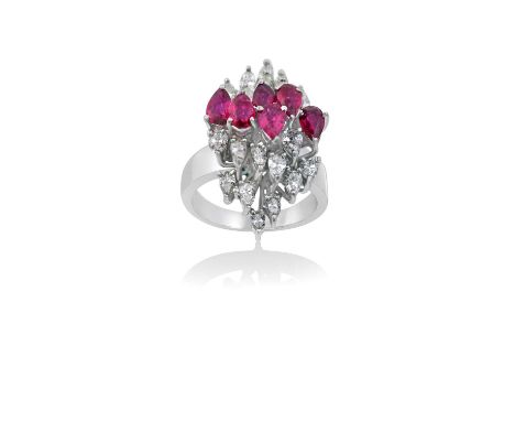 A Ruby and Diamond Cluster Ringan undulating row of pear cut rubies flanked by clusters of pear cut diamonds aligned up the f