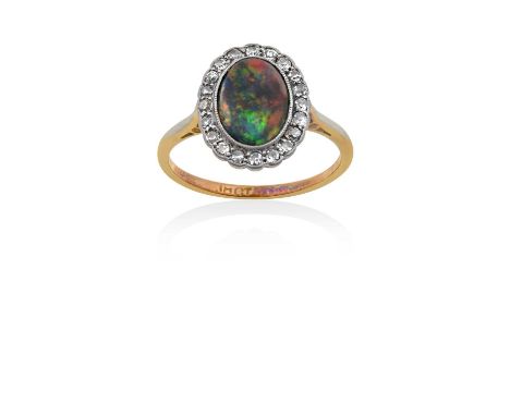 An Opal and Diamond Cluster Ringthe oval cabochon black opal within a border of old cut diamonds, in white millegrain and rub