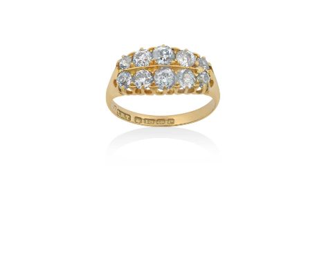 An 18 Carat Gold Diamond Ringtwo rows of graduated old cut diamonds in yellow claw settings, to a tapered shoulder plain poli