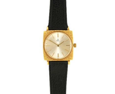 Ebel: An 18 Carat Gold Cushion Shaped Wristwatch, signed Ebel, circa 1970, manual wound lever movement, silvered dial with ba