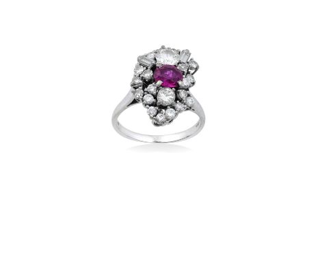 An 18 Carat White Gold Ruby and Diamond Cluster Ringthe abstract cluster with an oval cut ruby centrally to a border of round