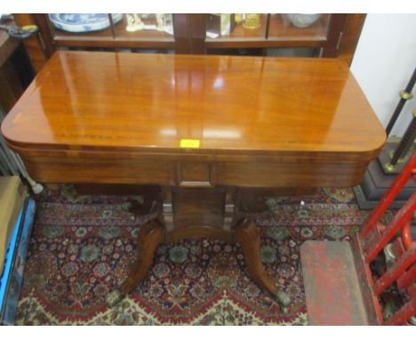 A Regency inlaid mahogany card table with a rotating top, on splayed legs 