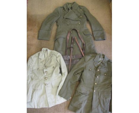 A WWII green woollen coat with Royal Artillery regimental buttons together with a Royal Artillery regimental khaki cotton dri