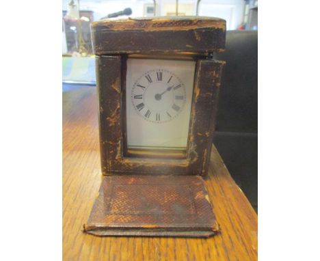 A late 19th/early 20th century carriage clock in a fitted travelling case, clock measures 14cm high including handle x 7.5cm 