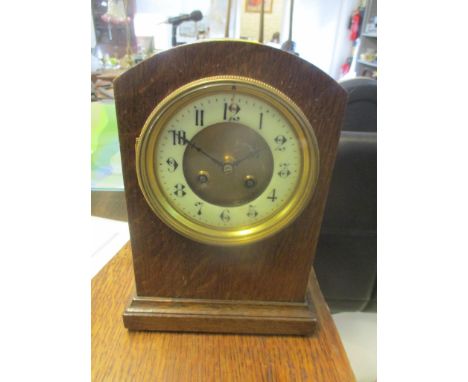 An early 20th oak mantel clock fitted with a French 8 day movement striking on a gong, 26cm h x 18cm w 