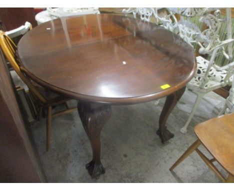 A 1920's mahogany dining table on cabriole legs and ball and claw feet, 73cm h x 132cm w 