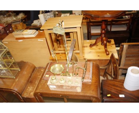 A set of Far Eastern brass scales on mahogany base; and a set of brass weights in wooden plinth