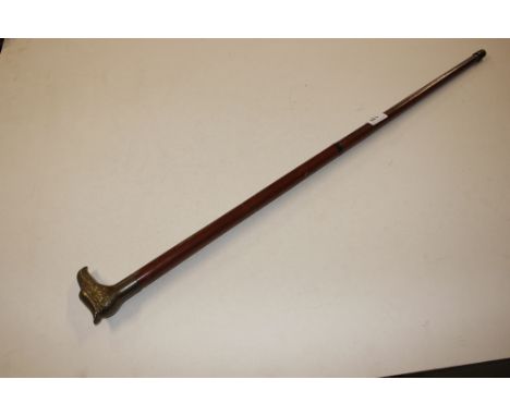 A walking stick with brass bird beak handle 