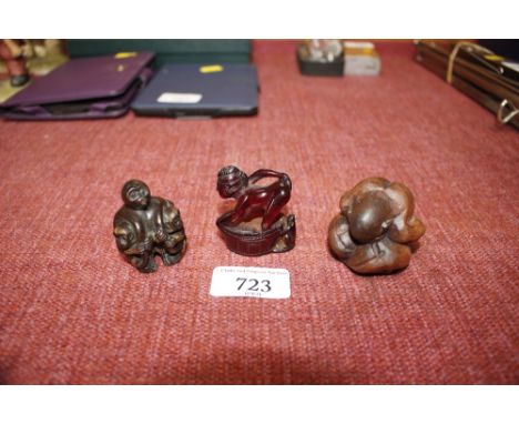 A box wood Netsuke figure; another depicting monkeys; and an amber coloured figural Netsuke 