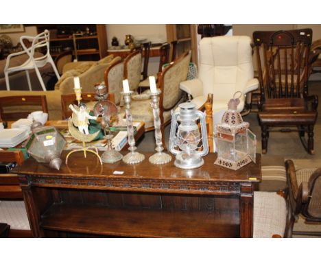 A stained glass hanging lantern; two other lanterns; a pair of candlesticks and two single candlesticks 