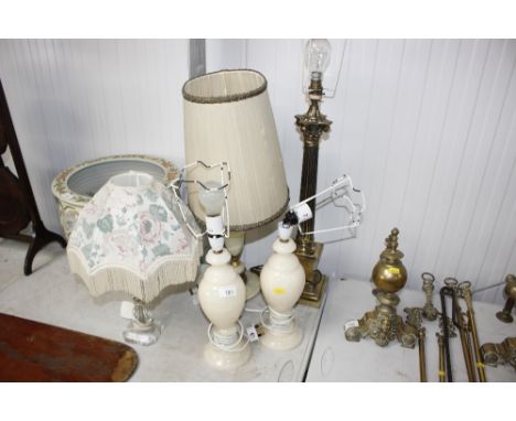 A brass Corinthian column table lamp; a pair of onyx table lamps; another similar; a glass table lamp; also some shades