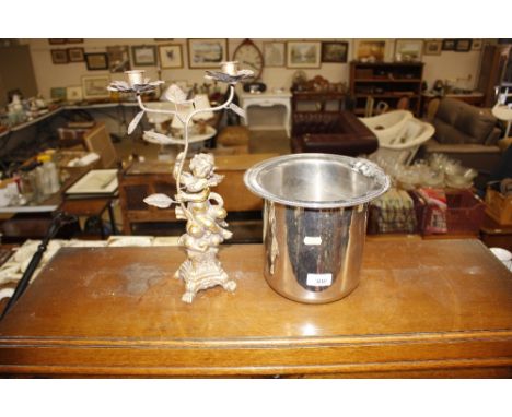 A plated ice bucket; and a brass cherub candelabra