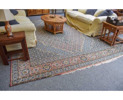 Machine made Carpet of Tabriz Design, the terracotta Herati field centred by a deep indigo medallion framed by spandrels and 